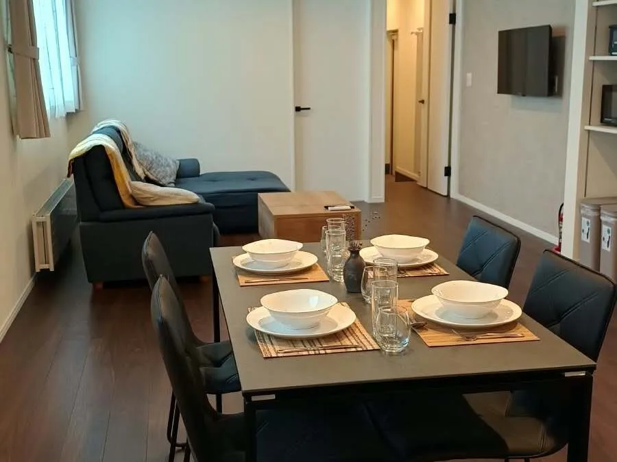 Dining table with lounge sofa in the background