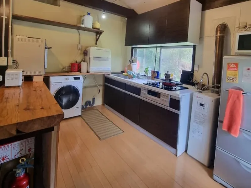 Kitchen with washing machine, gas hob and full-size fridge