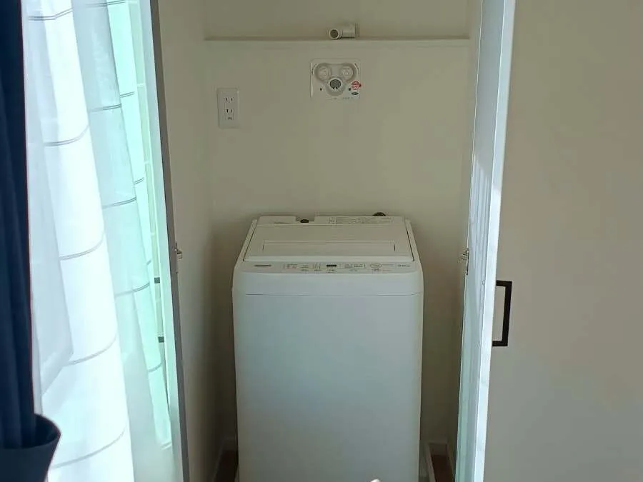 Washing machine in the closet with hangers