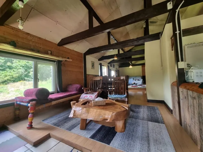 Living room with carved wooden coffee table and rocking chairs