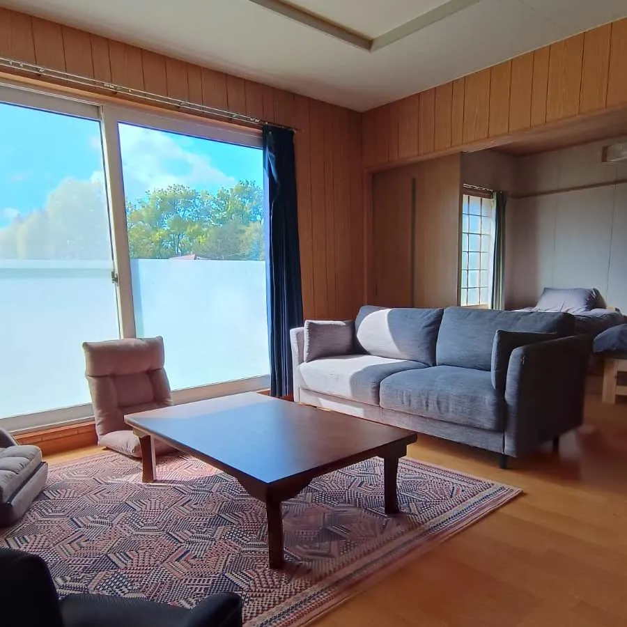 Wood-panelled living room with sofas and coffee table