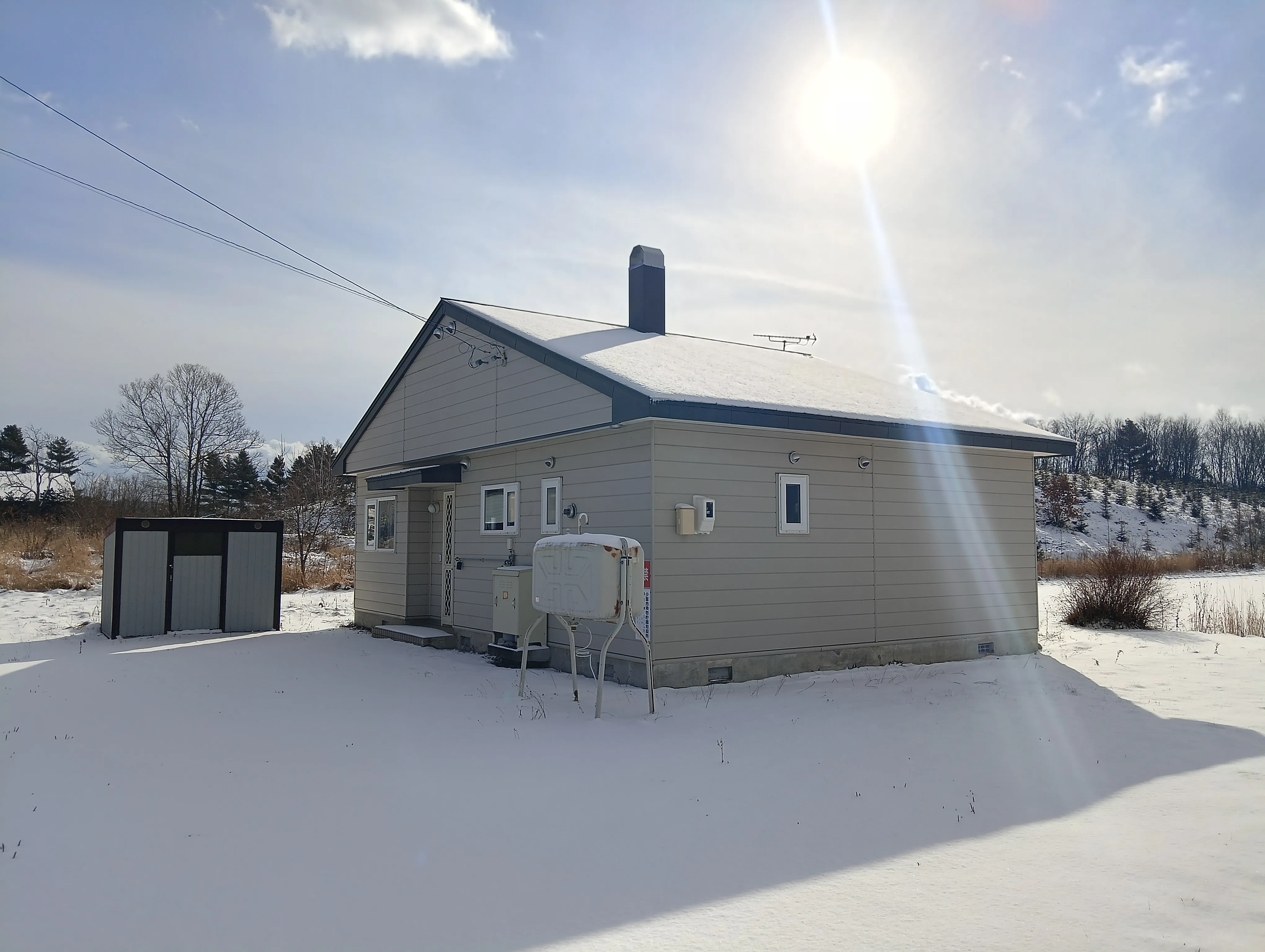 Snow-covered cottage exterior in winter
