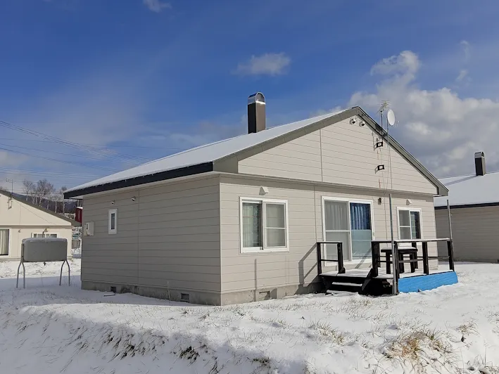 Snow-covered exterior with wooden deck