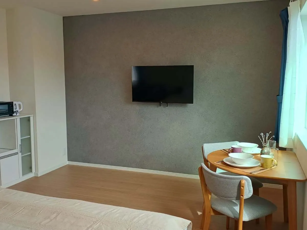 Dining area and TV wall in the King or Twin Studio Apartment